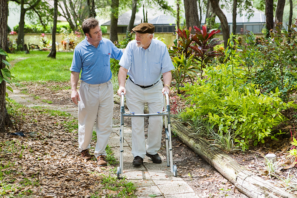 Lancaster, PA Caregiver and Senior Dementia Patient Walking in Garden