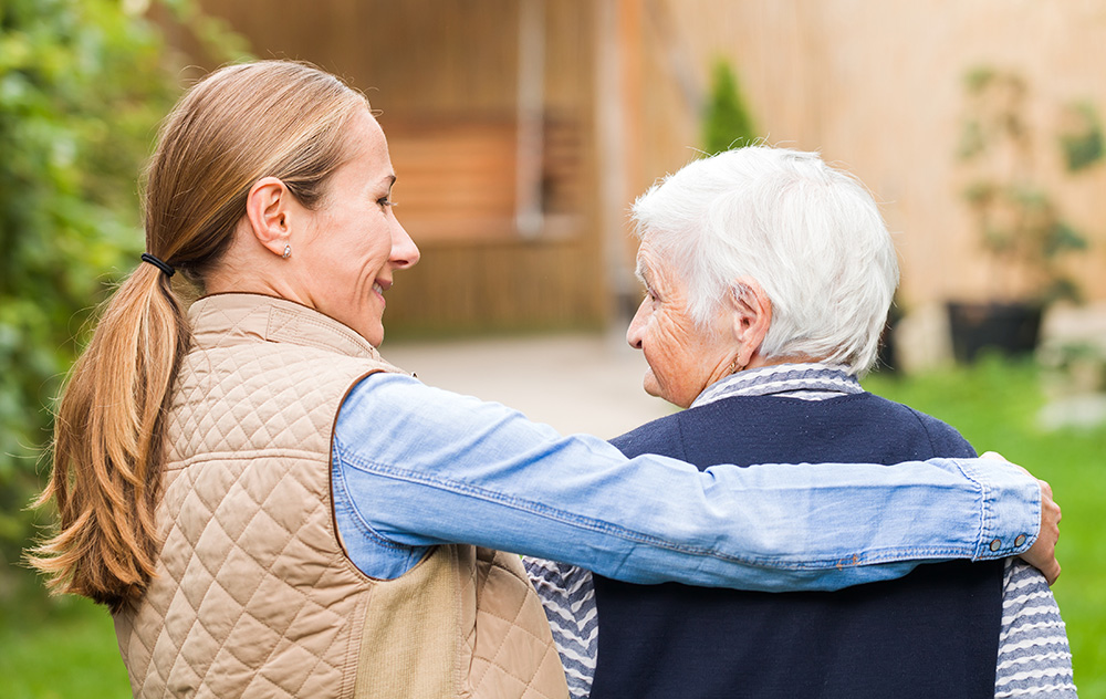 Caregiver and dementia patient walking