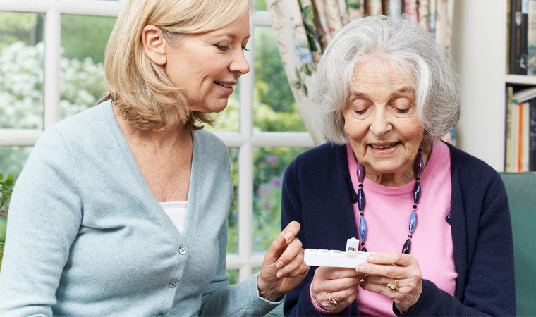 Caregiver helping patient with medications