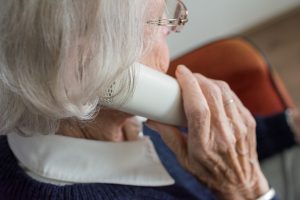 Elderly woman on the phone with a potential scammer